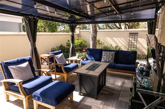 view of patio featuring outdoor lounge area and fence