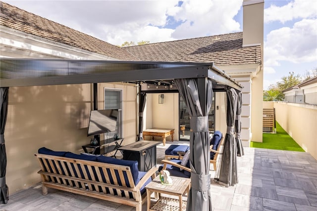 view of patio with an outdoor hangout area and fence