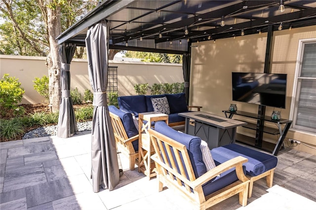 view of patio / terrace featuring an outdoor hangout area and fence