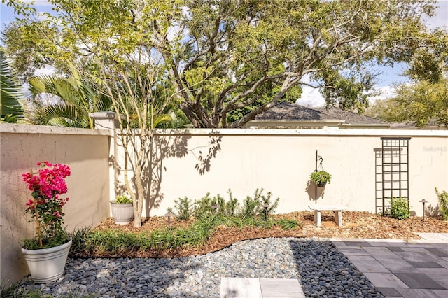 view of home's exterior featuring a patio area, stucco siding, and fence