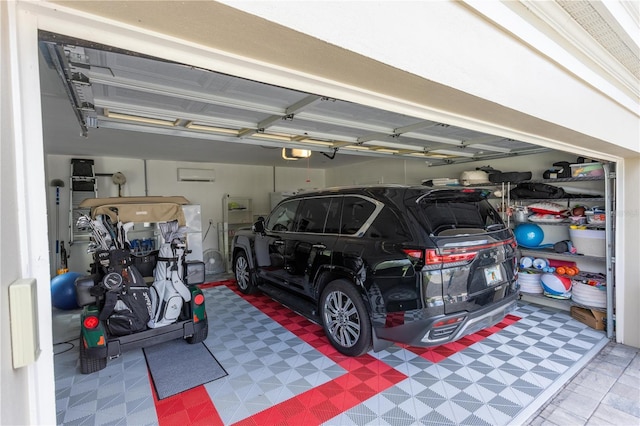 garage with a wall mounted AC and a garage door opener