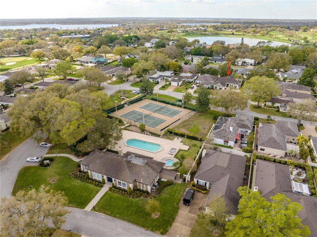 drone / aerial view with a residential view and a water view