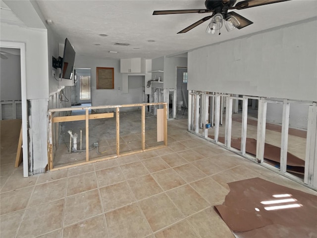 kitchen with a ceiling fan and tile patterned floors