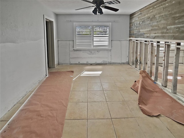 empty room featuring a ceiling fan and tile patterned floors