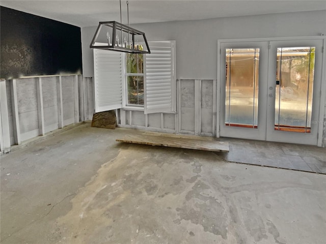 unfurnished dining area featuring concrete floors