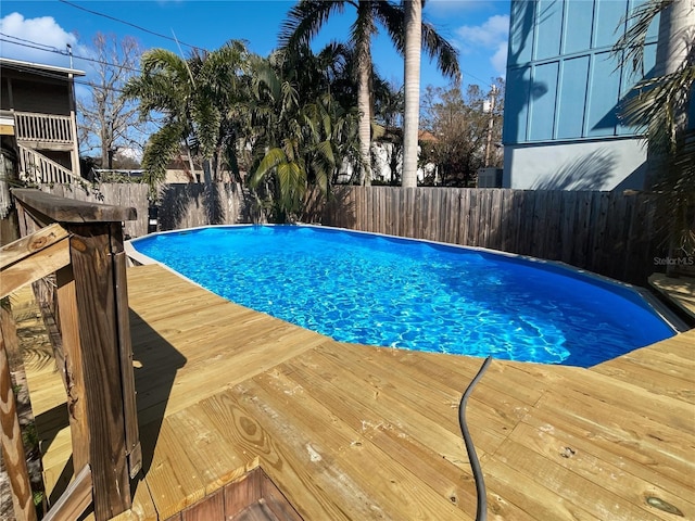 view of pool featuring a fenced backyard, a fenced in pool, and a wooden deck