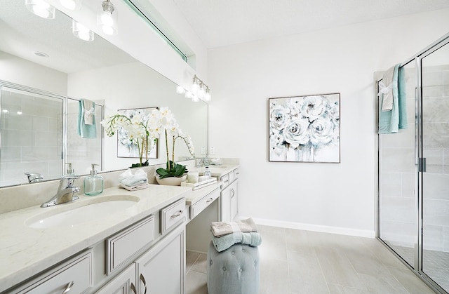 full bath with baseboards, a shower stall, and vanity