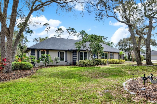 exterior space featuring a front lawn and stucco siding