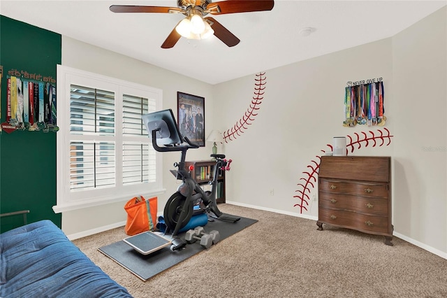 exercise room with ceiling fan, carpet, and baseboards