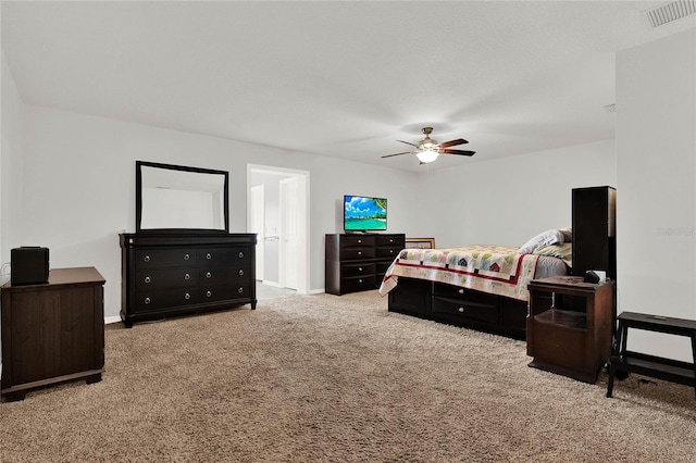 carpeted bedroom with visible vents, baseboards, and a ceiling fan