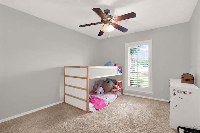 bedroom with ceiling fan, baseboards, and carpet floors