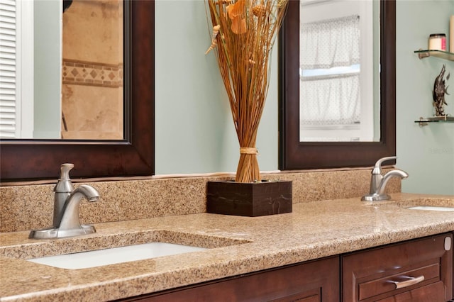 full bathroom with a sink and double vanity