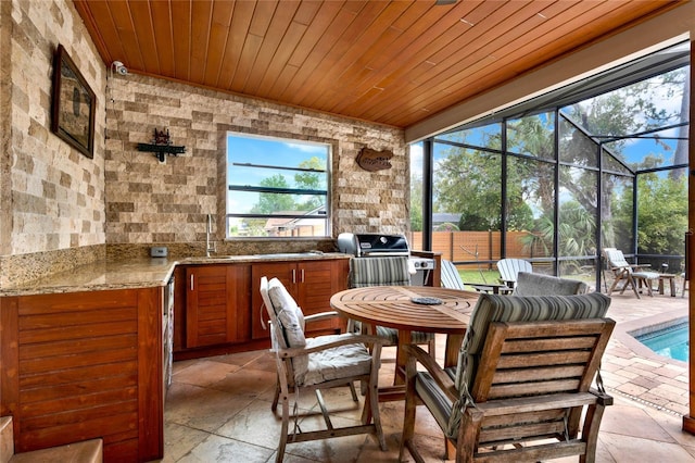 sunroom / solarium with wood ceiling and a sink