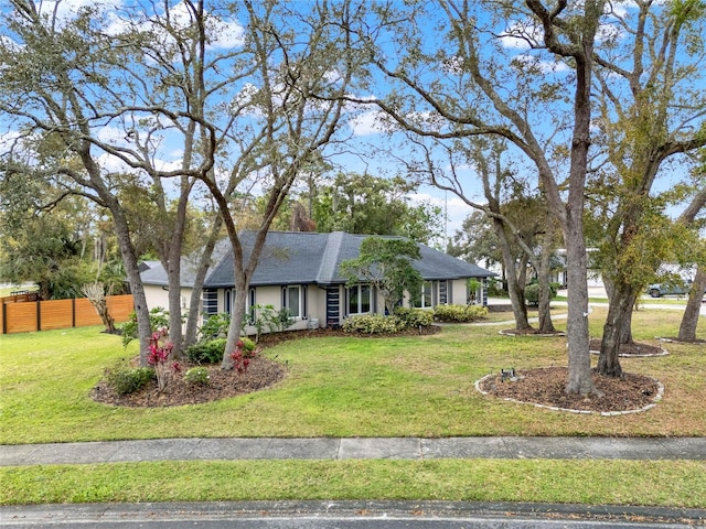 single story home featuring a front yard and fence