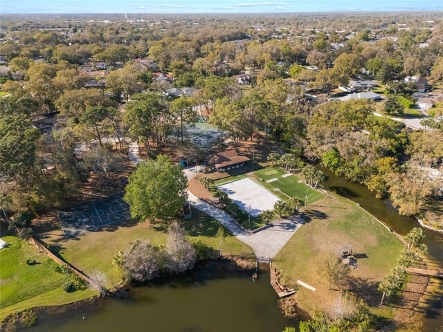 birds eye view of property featuring a view of trees and a water view