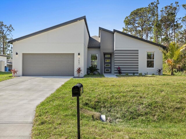24520 Kingsway Cir, Punta Gorda, FL 33983 - view of front of property featuring concrete driveway, a front lawn, an attached garage, and stucco siding