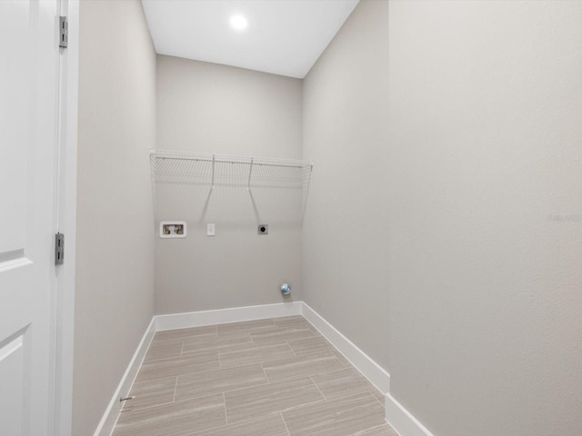 24520 Kingsway Cir, Punta Gorda, FL 33983 - clothes washing area featuring hookup for a washing machine, wood tiled floor, electric dryer hookup, laundry area, and baseboards