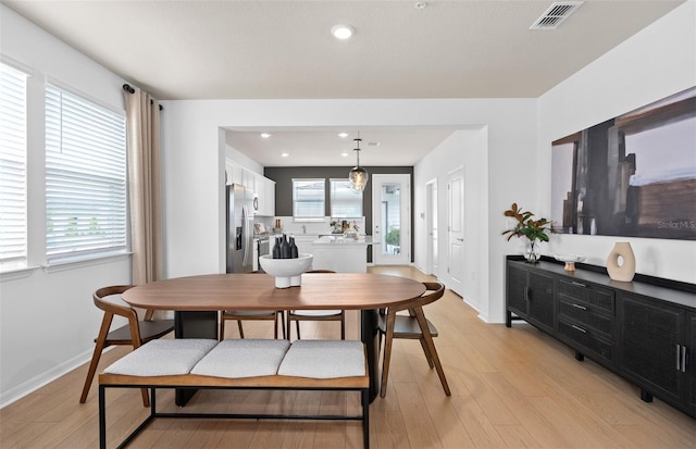 dining space with light wood-style flooring, visible vents, baseboards, and recessed lighting