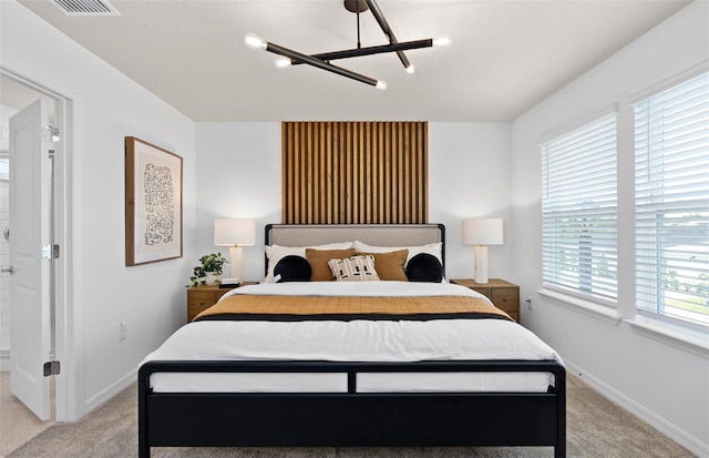 bedroom featuring light colored carpet and baseboards