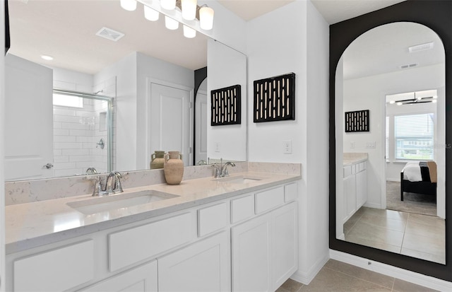 full bath featuring tile patterned flooring, a shower stall, visible vents, and a sink