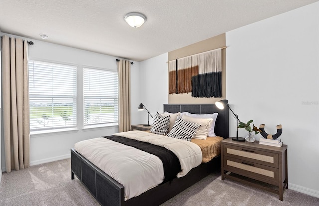 bedroom featuring carpet, a textured ceiling, and baseboards