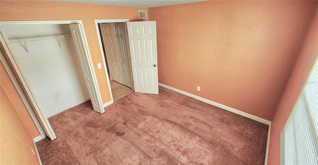 unfurnished bedroom featuring carpet flooring, visible vents, and baseboards