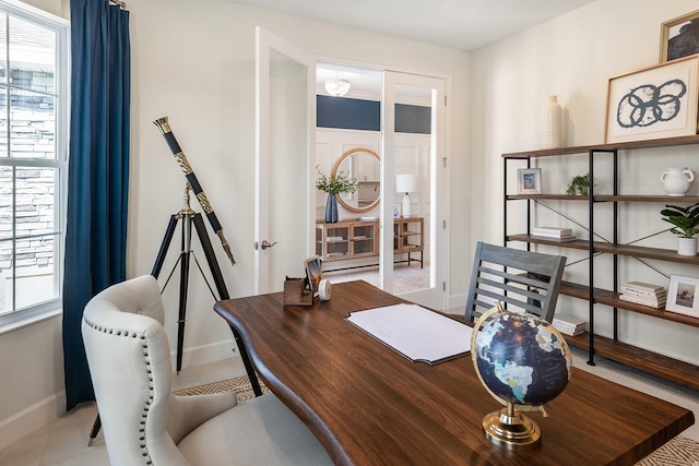 tiled home office with a healthy amount of sunlight and baseboards