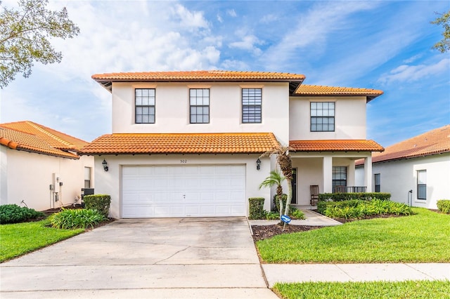 mediterranean / spanish home featuring a garage, cooling unit, concrete driveway, and stucco siding