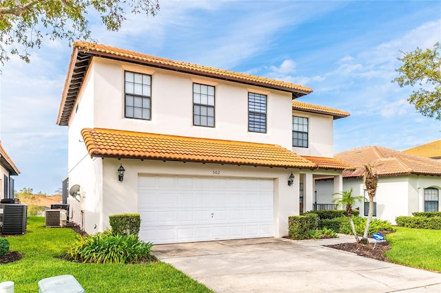 mediterranean / spanish house featuring concrete driveway, central AC unit, and stucco siding