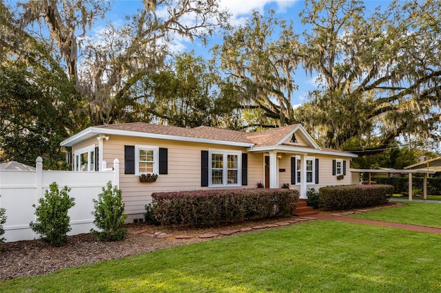 single story home featuring a front yard and fence