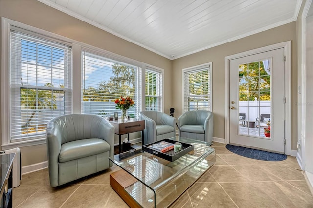 sitting room featuring ornamental molding, baseboards, and light tile patterned floors