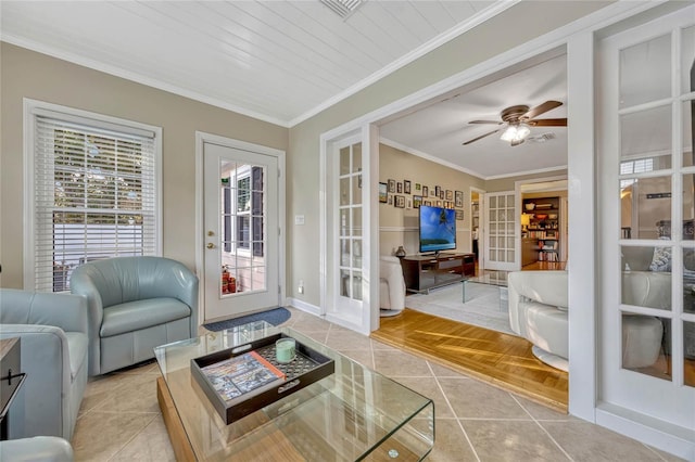 living room featuring a ceiling fan, baseboards, french doors, tile patterned floors, and crown molding