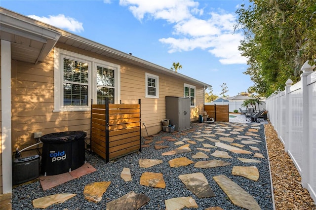 view of side of property featuring a fenced backyard and a patio