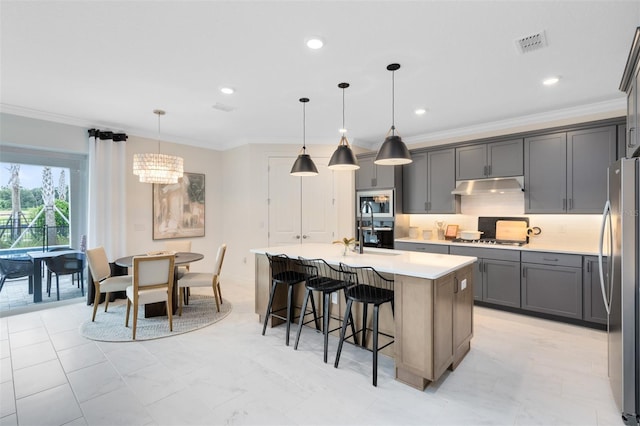 kitchen featuring under cabinet range hood, visible vents, stainless steel appliances, and ornamental molding