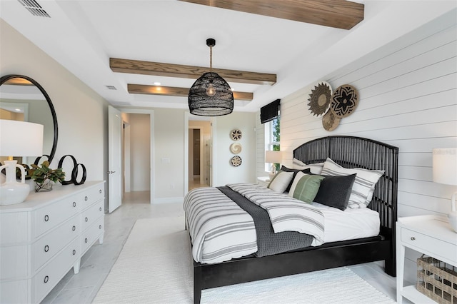 bedroom featuring beam ceiling, visible vents, and baseboards