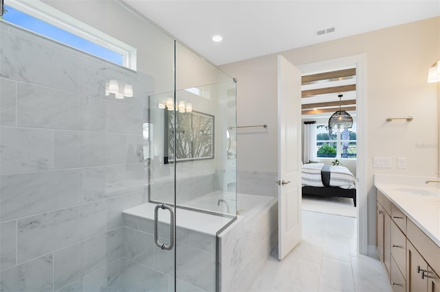 bathroom with visible vents, a shower stall, ensuite bath, vanity, and a bath