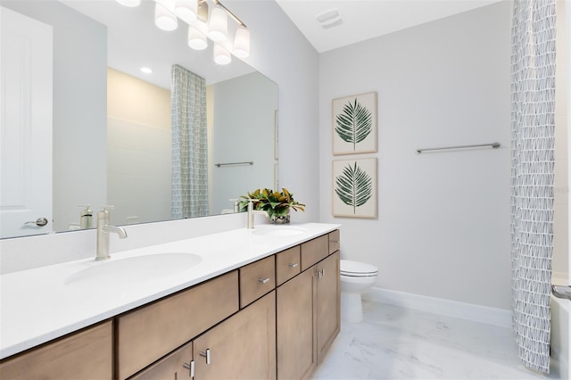 bathroom with marble finish floor, double vanity, toilet, a sink, and baseboards