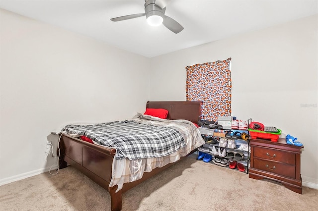 bedroom with carpet, a ceiling fan, and baseboards