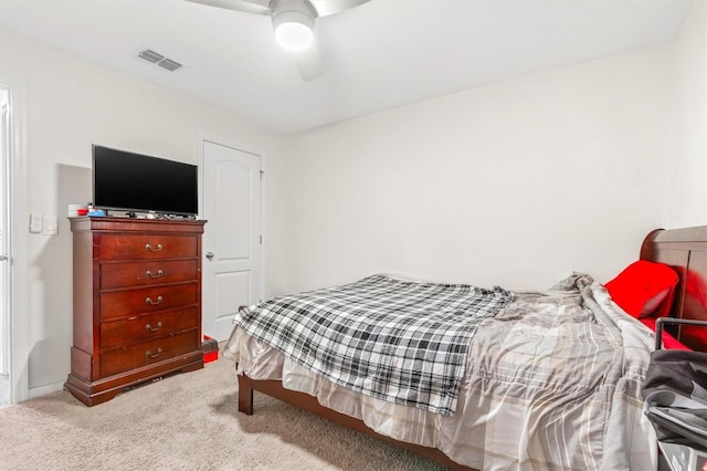 carpeted bedroom featuring visible vents and ceiling fan