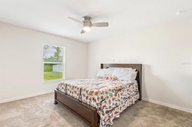 carpeted bedroom featuring ceiling fan and baseboards