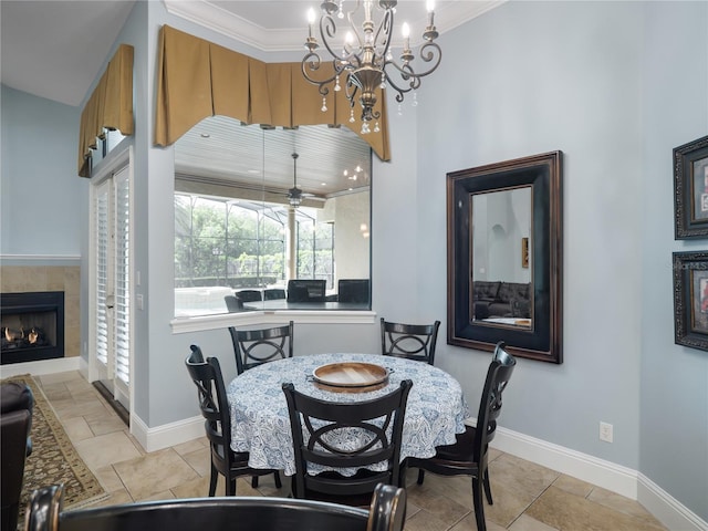 dining area with a sunroom, a fireplace, baseboards, and light tile patterned floors