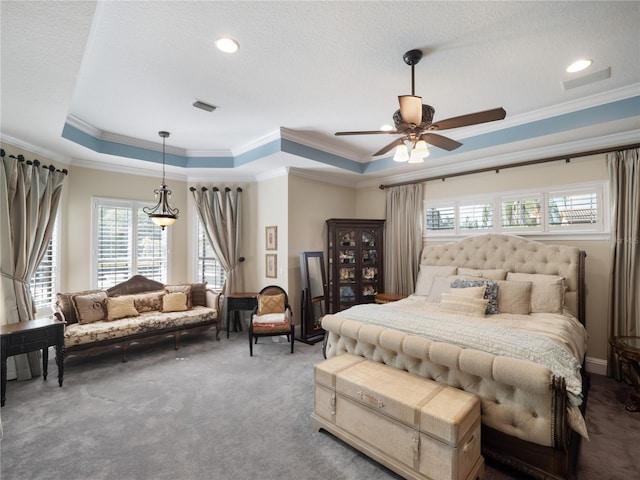 bedroom with visible vents, a raised ceiling, ornamental molding, carpet, and a textured ceiling