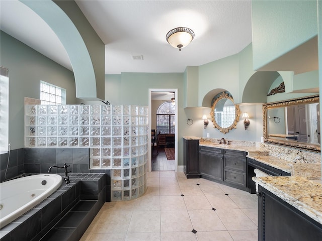 full bathroom featuring visible vents, ensuite bath, a tub with jets, tile patterned flooring, and vanity