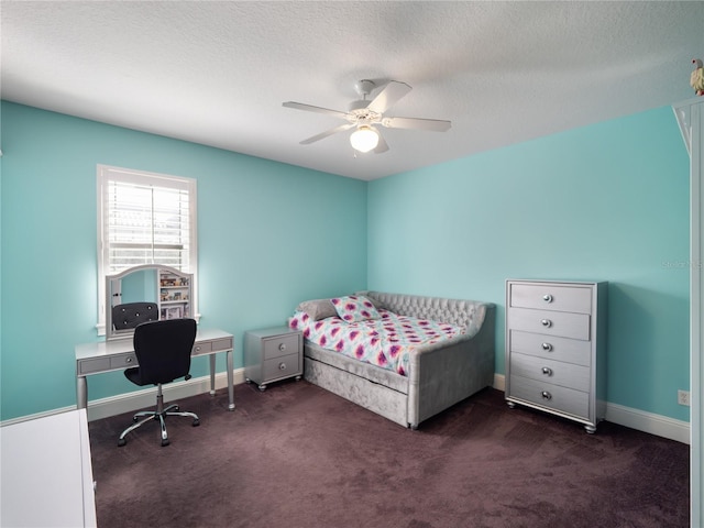 carpeted bedroom featuring a textured ceiling, a ceiling fan, and baseboards