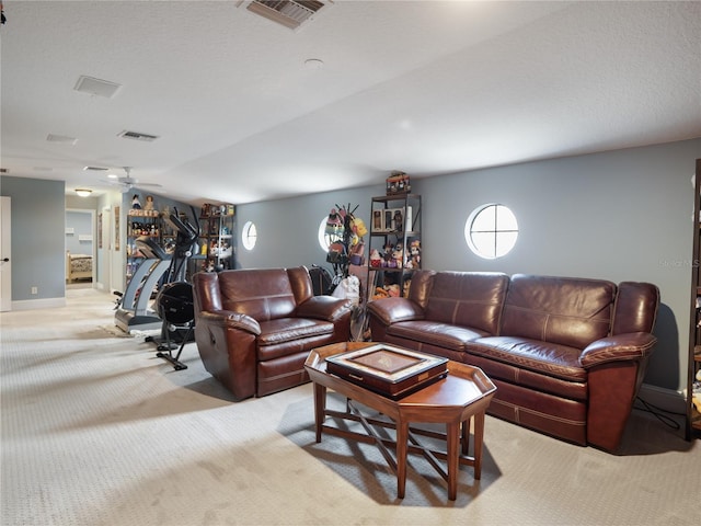 living room featuring visible vents, vaulted ceiling, a ceiling fan, and light colored carpet