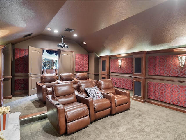 carpeted home theater room with lofted ceiling, visible vents, a textured ceiling, and recessed lighting