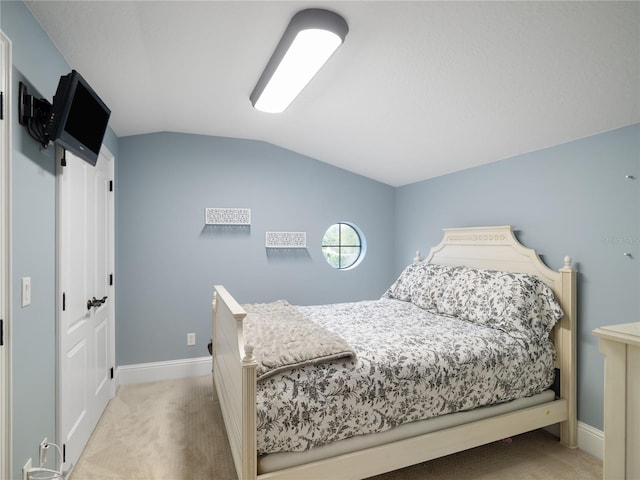 bedroom featuring carpet, baseboards, and vaulted ceiling