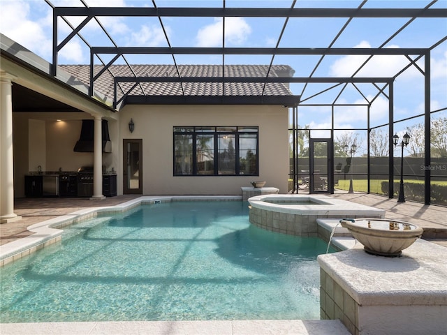 view of swimming pool with a pool with connected hot tub, a lanai, a patio, and an outdoor kitchen