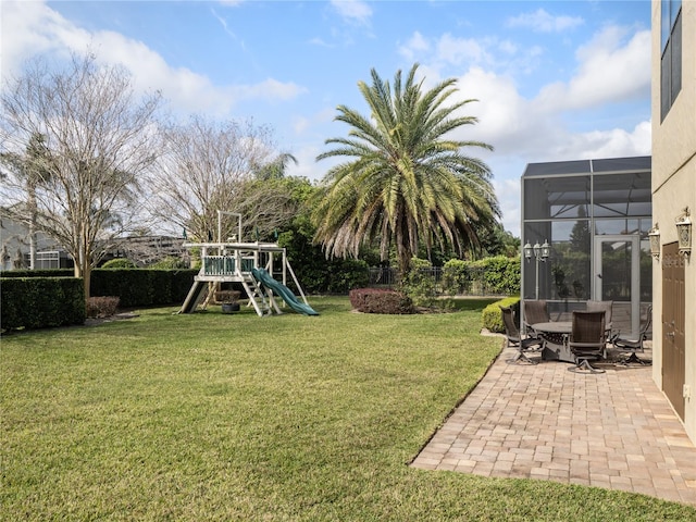 view of yard featuring a patio area, a playground, and a lanai