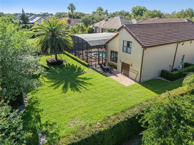 12860 Jacob Grace Ct, Windermere, FL 34786 - back of house featuring a patio area, a yard, stucco siding, a tiled roof, and glass enclosure